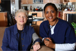 caregiver and an elderly wearing blue clothes